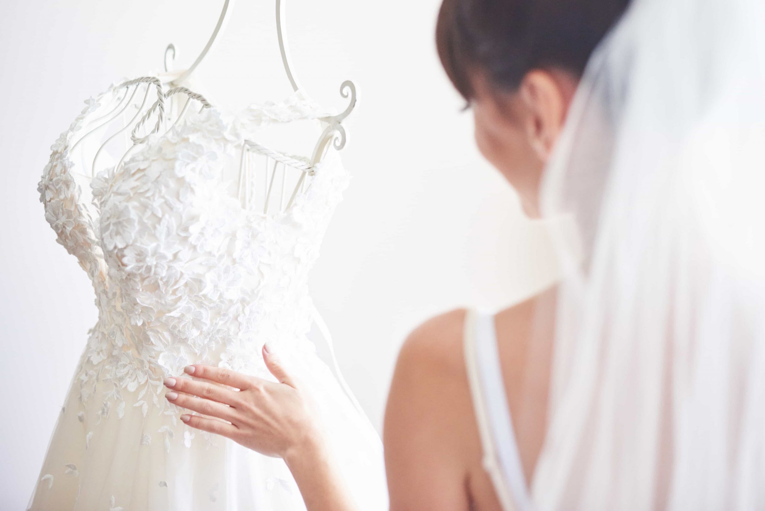 elegant-bride-puts-wedding-gown-her-room